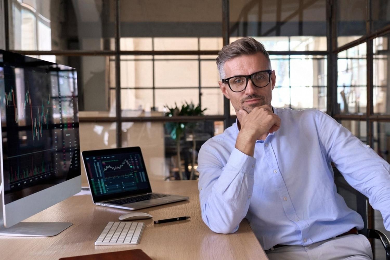 Senior professional reviewing performance data on screens in a Dubai office